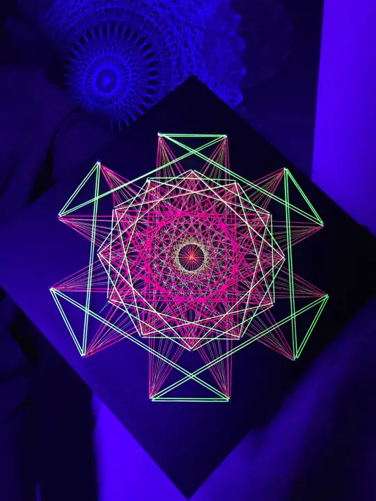 String art with neon string under blacklight