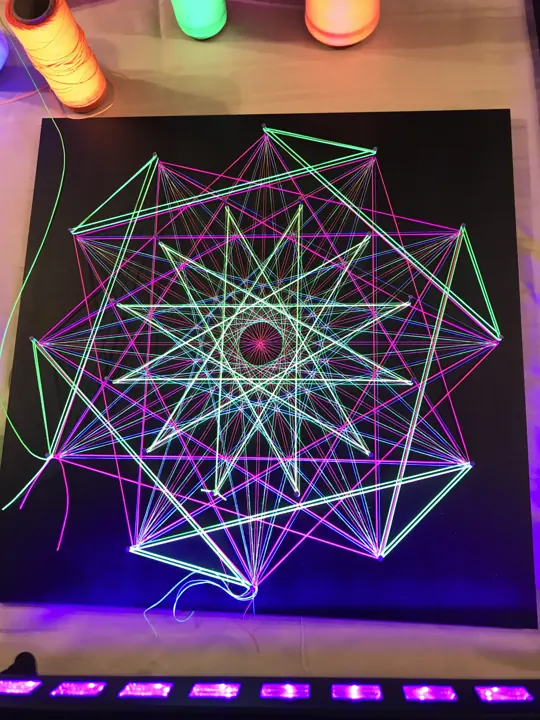 String art with neon string under blacklight