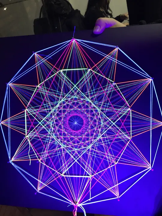 String art with neon string under blacklight