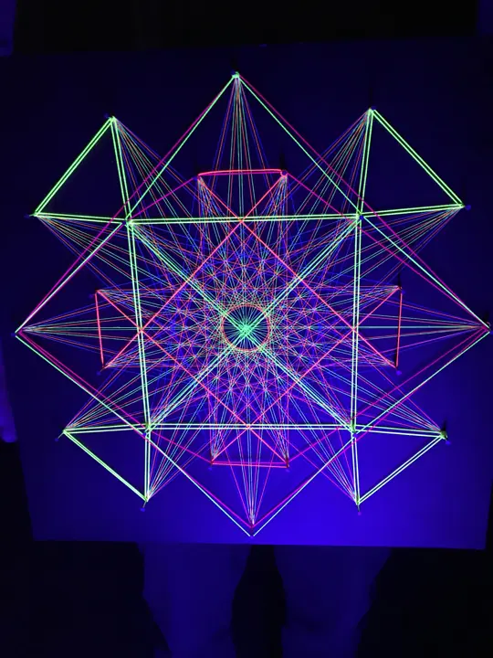 String art with neon string under blacklight