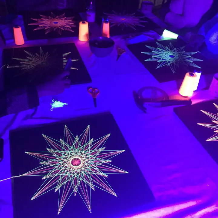 String art with neon string under blacklight