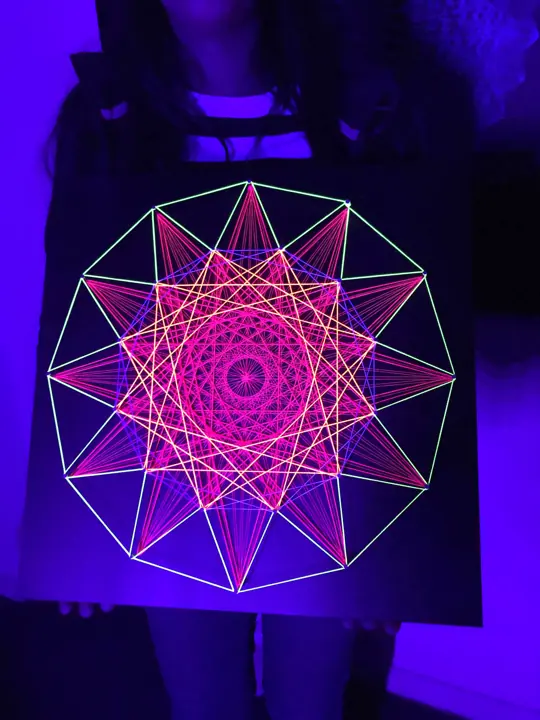 String art with neon string under blacklight