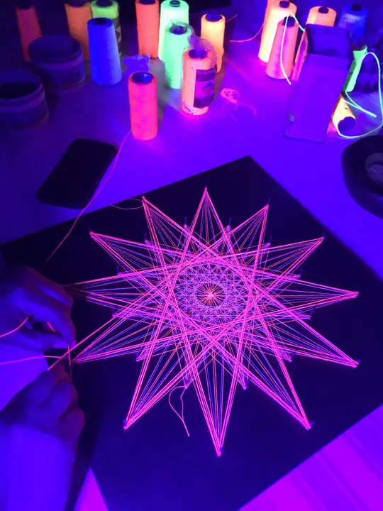 String art with neon string under blacklight
