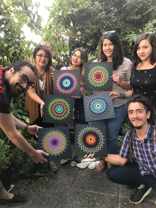 Group from a Fractalería string art workshop with their pieces