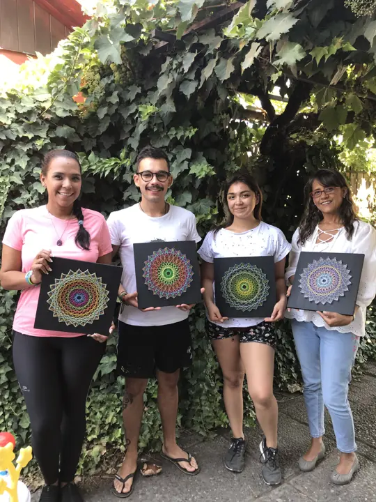 Group from a Fractalería string art workshop with their pieces