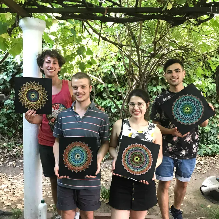 Group from a Fractalería string art workshop with their pieces