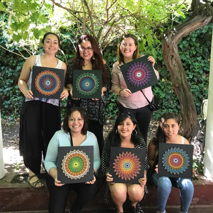 Group from a Fractalería string art workshop with their pieces