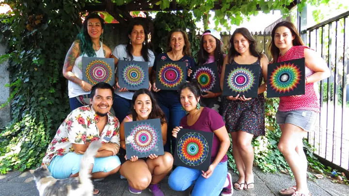Group from a Fractalería string art workshop with their pieces