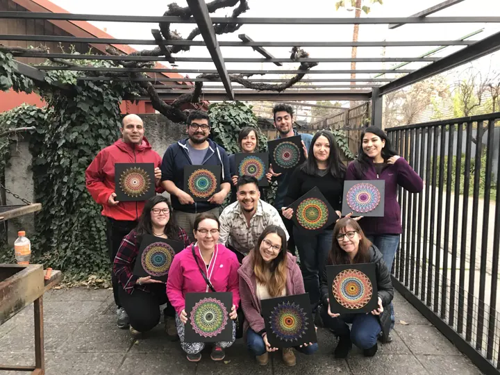 Group from a Fractalería string art workshop with their pieces