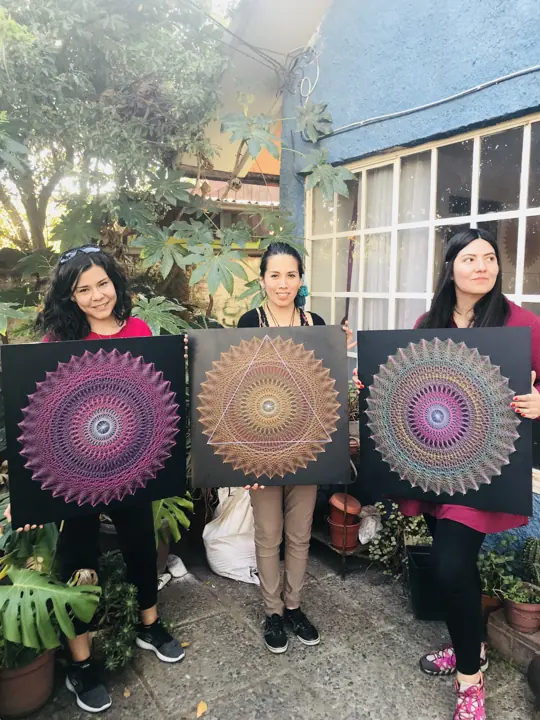 Group from a Fractalería string art workshop with their pieces