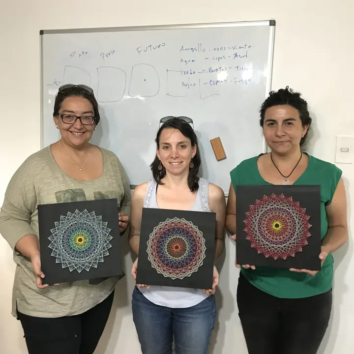 Group from a Fractalería string art workshop with their pieces